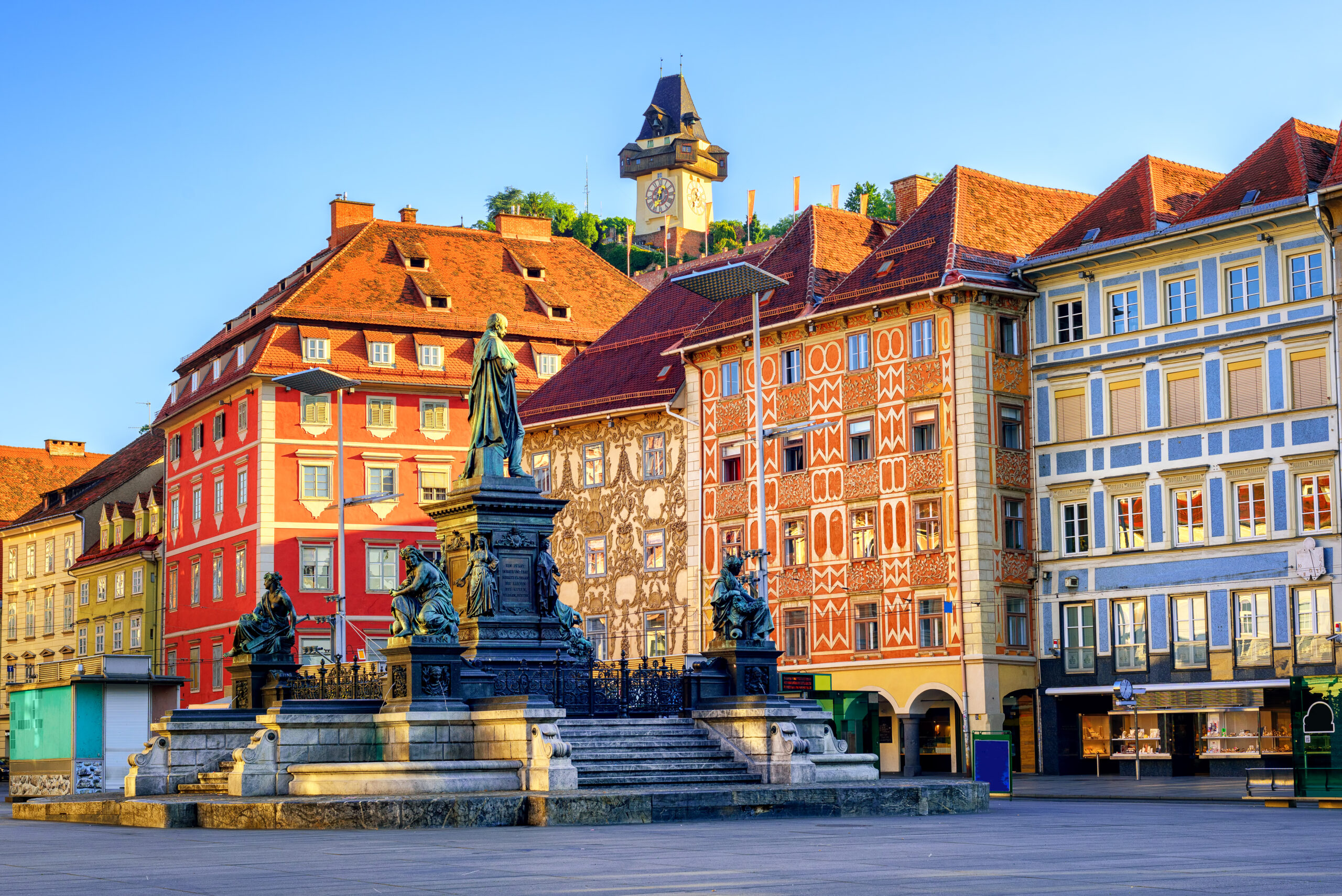 Painted facades and the Clock Tower in the old town of Graz, Austria